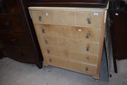 A 20th century light wood chest of five drawers, with moulded detail and pendants 104cm x 86cm x