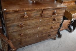 A 19th century mahogany chest of 2/3 drawers, each with turned wooden knob handles, raised on