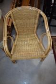A 20th century wicker and rattan armchair presented in good, clean and solid condition, seat h41cm x