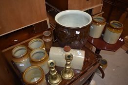 A group of stoneware jars, sold together with a pair of brass candlesticks ect