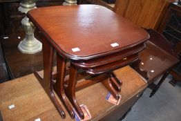 A nest of three stained mahogany tables, of rounded rectangular form, largest 46cm x 57cm x 49cm