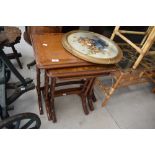 A vintage nest of tables having bamboo style legs, h55cm, sold together with a circular painting (