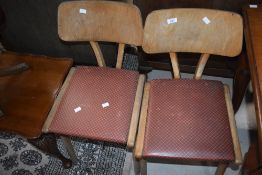 A pair of mid century elm and plywood children's chairs, with rexine covered seats 46cm seat height