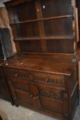 A reproduction oak sideboard in the 17th/18th century style with Nulled drawers and carved and