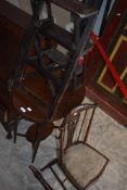 A set of stained pine metamorphic library steps with hinged action, sold along with an Edwardian