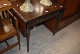 A late 19th/early 20th century mahogany sofa table, with rounded end leaves, two frieze drawers
