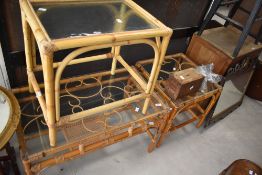 A vintage wicker coffee table having glass top and rattan magazine rack, L78cm, sold together with
