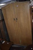 A 20th century mahogany double door wardrobe with moulded ornaments 195cm x 110cm x 56cm