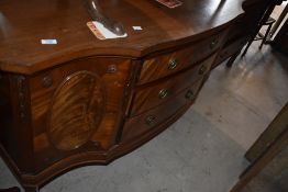 An Edwardian mahogany sideboard with shaped breakfront top above an arrangement of drawers and