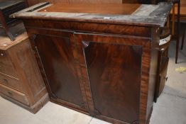 A 19th century mahogany bookcase top, with moulded cornice and panelled doors with fluted