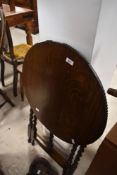 An early 20th century flip top side table having barley twist legs, h69cm