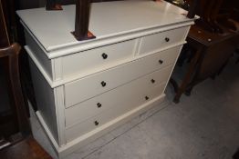 A modern white painted chest of drawers, with 2/3 arrangement 92cm x 115cm x 42cm