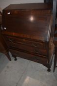 A 20th century mahogany bureau, of typical arrangement on short cabriole type legs 104cm x 75cm x