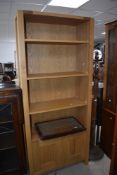 A modern light oak bookcase with three adjustable shelves over two cupboard doors 188cm x 81cm x