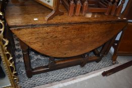 A 19th century oak drop leaf table, L116cm