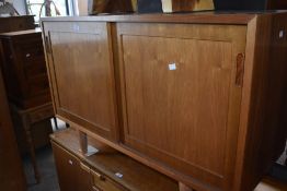 A Danish Furniture Makers two door cabinet, of rectangular form with two sliding doors enclosing the