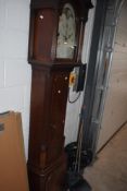 A Victorian mahogany eight day long case clock, having a broken swan neck pediment with central gilt