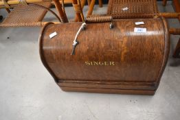 An early 20th century Singer sewing machine with carry case, sold together with a tea caddy, (2)