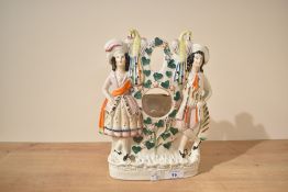 A Staffordshire pottery pocket watch holder sold along with an alabaster style table lamp base.