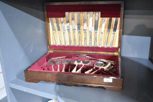An oak canteen having red felt interior containing stainless steel cutlery, (55)