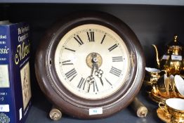 A vintage Continental painted metal circular wall clock, with exposed movement and two cylindrical