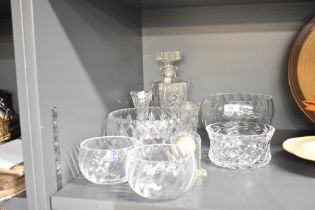 A selection of cut glass items comprising decanter, mantel clock and bowls of various sizes etc.