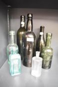 Seven vintage green glass and advertising bottles including a Wilkinson's Collin Croft Brewery
