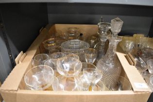 A cut glass biscuit jar, three cut glass decanters, and a selection of assorted spirit glasses in