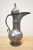 A pewter pitcher in the Eastern style decorated with geometrical patterns, h40cm
