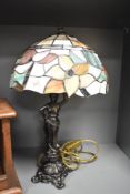 A modern cast metal figural table lamp with leaded Tiffany style glass shade 51cm overall.