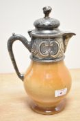 A Doulton Lambeth pottery pitcher having silver plated lid decorated with acanthus leaf patterns,