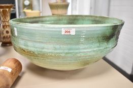 A large studio pottery bowl having a green glaze, w46.5cm