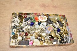 An assortment of costume jewellery, including brooches, clip-on earrings, and stud earrings