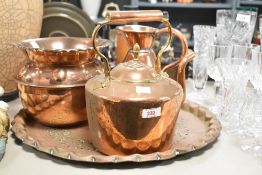 A selection of copperware including kettle , haystack jug and pierced tray