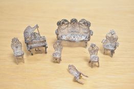 A small selection of white metal filigree miniatures, comprising salon suite and grand piano,