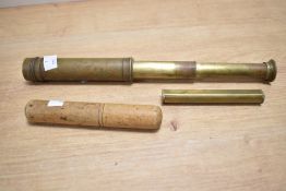 A 19th / 20th century brass three-draw telescope, sold together with a level ect
