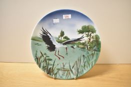 A ceramic plate decorated with stork/heron motif, w30.5cm