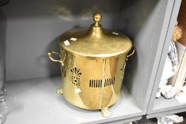 A Victorian brass coal scuttle , having ball finial to lid , two handles and three paw feet, with