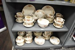 An early 20th century Limoges of France dinner service having gilt edges and floral patterns,