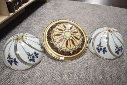 A group of three light fittings, one in the Tiffany style.