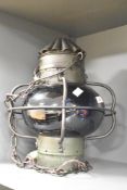 An Alfred F.S Genton blue glass nautical lamp with vented cowl and protection ring 34cm overall