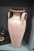 A large decorative pottery amphora type urn/vase with twin strap handles and mottled glaze 73.5cm