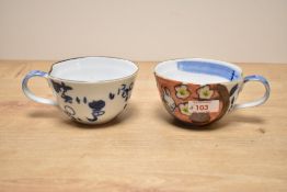 A pair of Japanese style cups hand coloured with Rabbits and calligraphy, h7cm,(2)