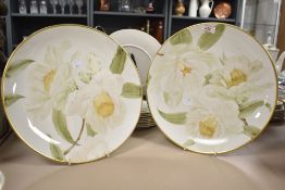 A pair of large decorative plates having hand painted design and gilt decoration to rim, with script