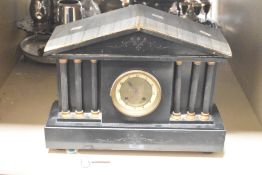 A 19th Century black slate eight day mantel clock having Arabic chapter ring, flanked by trio of