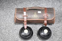 A pair of lawn bowling balls, sold together with leather case