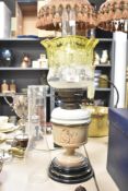 A late 19th or early 20th Century oil lamp having ceramic reservoir and glass shade, with two