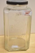 A vintage moulded glass 'Sanatogen' supplement jar, with screw off cover 20.5cm