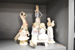 A group of porcelain figures, to include girl with goat and girl with bird ect
