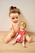 Two Dolls, 1960's Hong Kong Penny Brite Doll wearing red and white dress and a Made in England